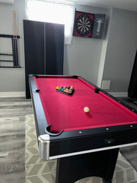 Pool table with cues and set up 