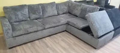 BRAND NEW GRAY REVERSIBLE SECTIONAL WITH CUP HOLDERS, STORAGE AND USB CHARGING PORT (STILL IN BOXES)...
