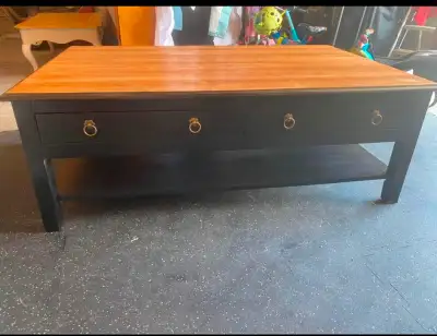 Excellent solid wood coffee table! 2 big drawers for storage and more storage underneath on the shel...