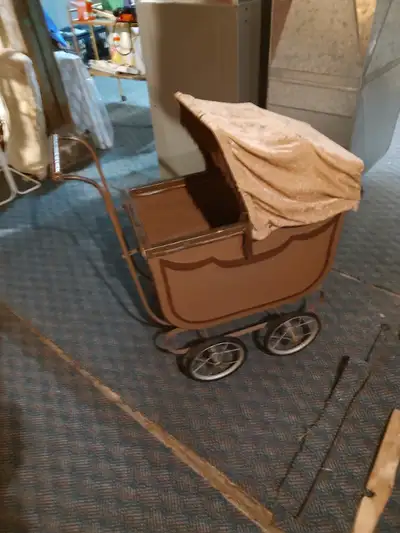Antique metal doll buggy/carriage. Hood cover is not original.