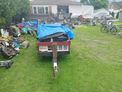 Old boat trailer converted to garbage hauler. Still have bolt on boat cribs.