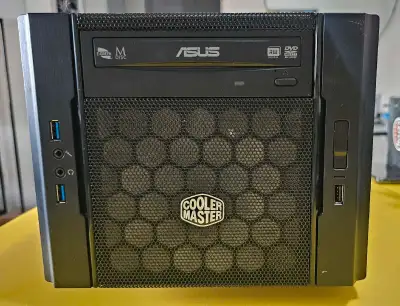 This is a used Cooler Master Mini ITX case, perfect for a compact PC build, featuring an ASUS DVD RW...