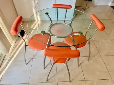 Round glass table set with four chairs, View more