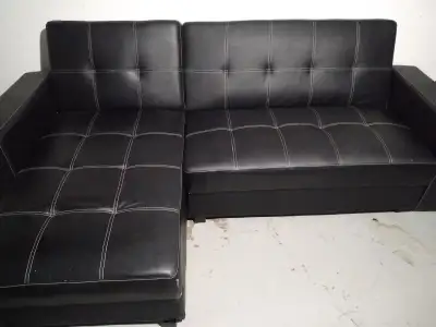 Black leather couch that folds into a bed, View more