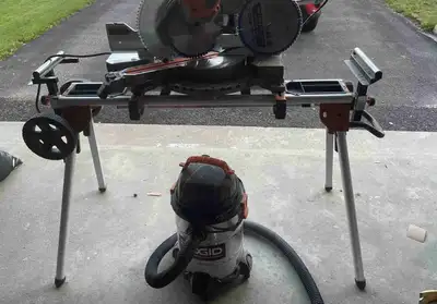 This pre-owned Ridgid miter saw comes complete with a heavy-duty rolling stand and a matching Ridgid...