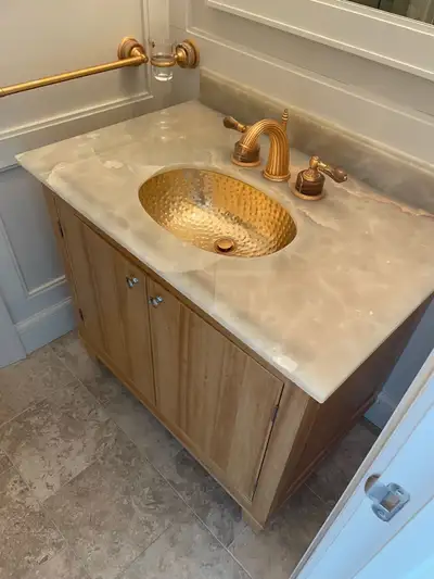 Custom onyx vanity w hammered copper sink, all brass hardware in, View more