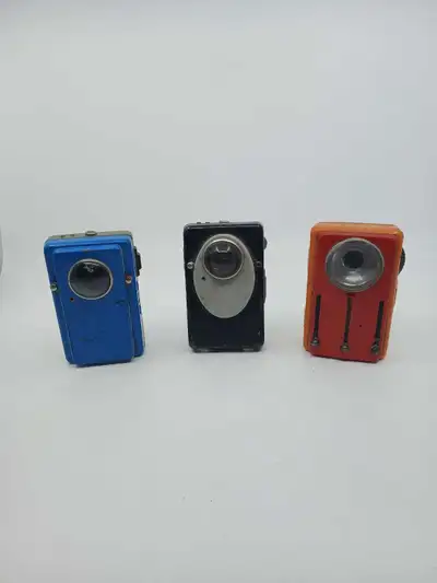 Set of three metal signal flashlights, each with a unique design and colour. These were used by the...