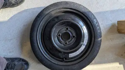 Good condition spare tire almost looks unused. From 2005 Honda civic, fits other years as well .