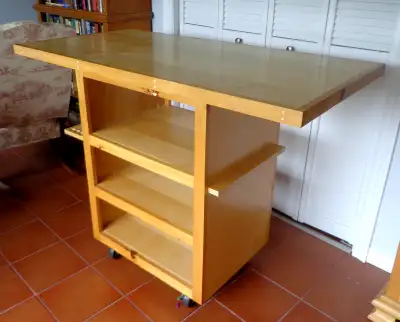 This custom made rolling cart was made for a workshop. It has a large top with a 3 shelf cabinet ben...