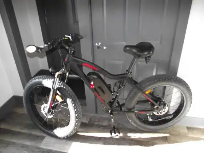 Electric bike with fat tires. Black body with red lettering, beautiful looking machine! The seat is...