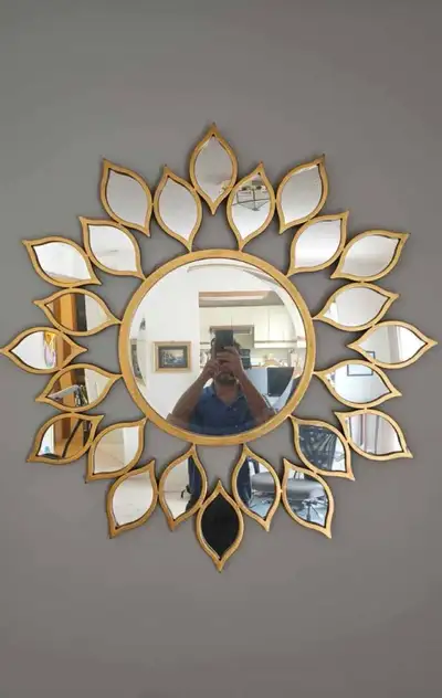 Add a touch of sunshine to any room with this decorative 39-inch sun-shaped wall mirror, featuring a...