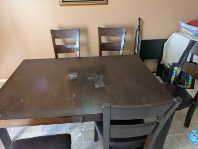 Selling our kitchen table with 6 chairs. The color is dark brown. The table has some marks on it, se...