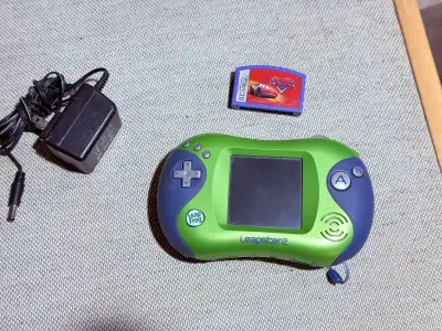 LeapFrog Leapster 2 educational handheld video game system. Come with one car racing game and power...
