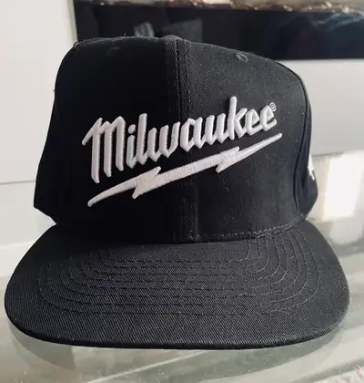 Black Milwaukee FUEL snapback hat with embroidered logos. One size fits most with adjustable snap cl...
