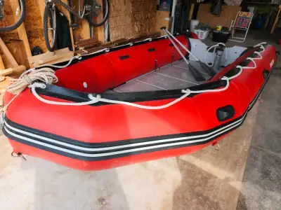 14ft. Zodiac type inflatable boat great fishing or cruising around. Aluminum sectional flooring, pad...