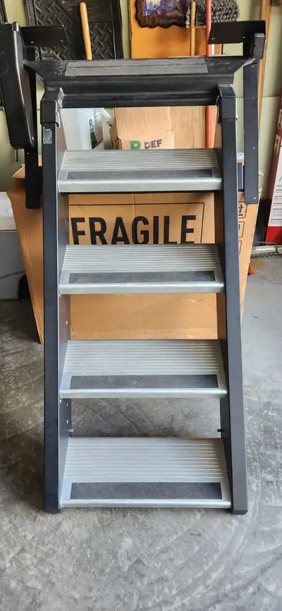 The StepAbove stairs by MORyde are mounted on the inside of the RV over the doorway threshold and ar...