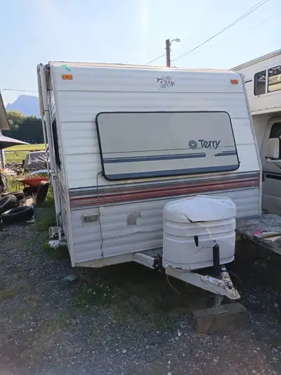 Terry Resort travel trailer. Dual axle, 22ft. Needs patching on roof. Includes propane tanks. Clean