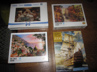 FOUR 1000 PIECE PUZZLES WITH LETTERS ON THE BACK OF EACH PIECE