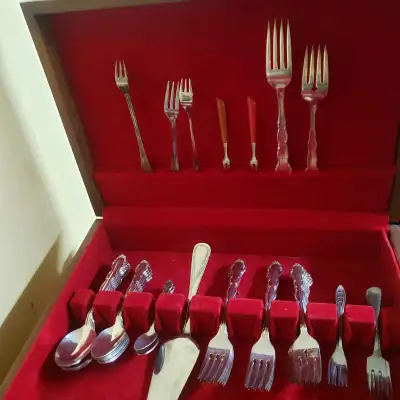 This is a used 1847 Rogers Bros flatware set in a wooden case, perfect for adding a touch of vintage...
