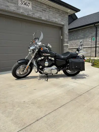 I am selling my used Harley Davidson Sportster 1200 Custom. It features a 1200cc engine, a sleek bla...