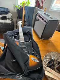 Fender electric guitar with Fender Amplifier and guitar case. 