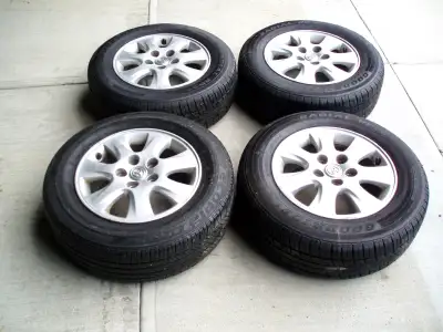 4 Toyota Camry aluminum wheels with tires. 205/65R15. One tire has a different tread. Used 1 summer....