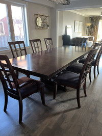 Solid espresso wood dining table with 8 chairs - $1000