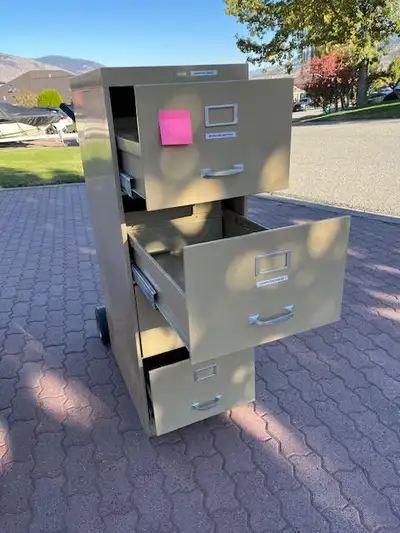 STURDY 4 DOORS METAL FILING CABINET CLEAN IN VERY GOOD CONDITION COLOUR TAN NO / S NO /P $55 ALSO 15...