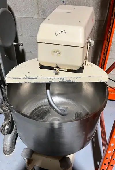 Two-speed spiral mixer for dough. Both the dough arm and the bowl are in operation. It operates on a...