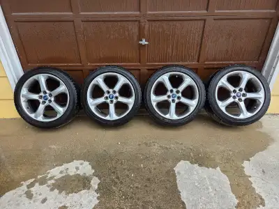 Four 235/45R18 Goodyear Eagle Sport All Season tires on aluminum rims for sale. They have around 7/3...