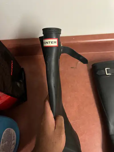 These are pre-owned black Hunter boots in men's size 11. They've seen a few puddles in their time an...