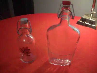 Two HD glass bottles with compression tops for sealing. One is 10" high and the other 7" high. $10 f...
