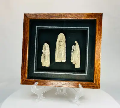 This remarkable framed set of three antique votive plaques originates from Cambodia or Thailand, dat...