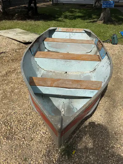 This sturdy aluminum fishing boat features a durable metal hull and simple bench seating, making it...