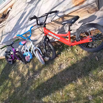 Children's bicyles for sale: LIKE NEW red Strider bike - suitable for older children ages 5-6 and up...