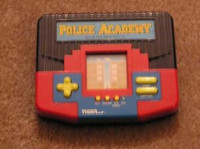 Police Academy Handheld Electronic Video Game - $45