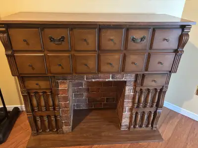 Record player, 8 track cassette and radio with fireplace ( no insert for the fireplace). Also has a...