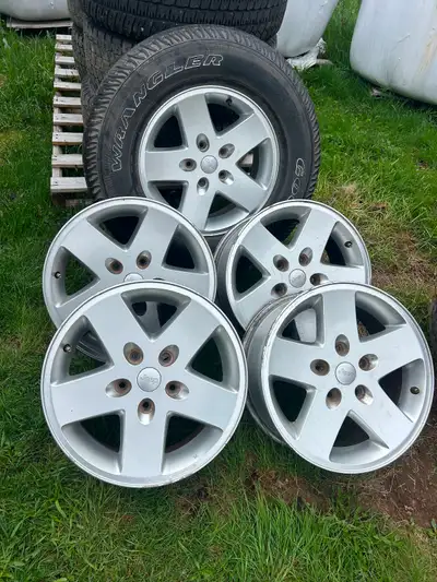 5 - 17 inch aluminum rims for sale, excellent condition. One has a 265/ 70 r 17 tire on it. $350.00