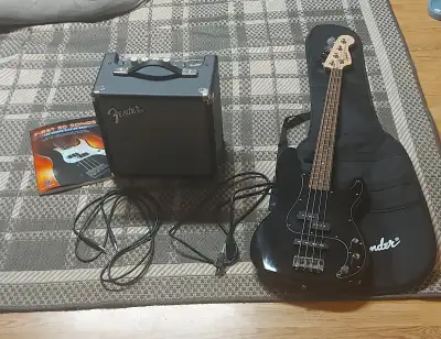One Squier Affinity Series Precision bass guitar, a padded gig bag, Rumble 15 bass amp, and a 10-inc...