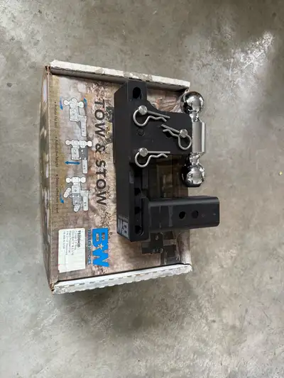 This is a Tow & Stow adjustable trailer hitch, designed with a 2 5/16" ball and a black powder coat...