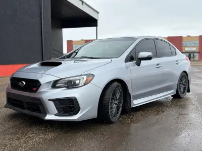 The 2020 Subaru WRX STI is a performance-focused sedan featuring a 2.5L turbocharged Boxer 4-cylinde...