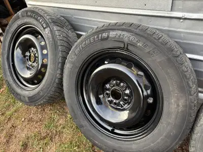 Selling 4 Michelin Ice winter tires, size 245/60R18, mounted on black powder coated steel wheels. Th...