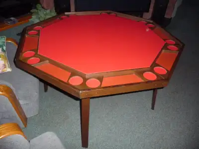 Eight position poker/games table. 48” across. Vinyl top. Legs fold for storage. Good condition.