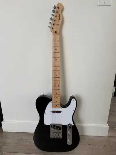 Squier Affinity Telecaster by Fender in a classic black finish with white pickguard and maple fretbo...
