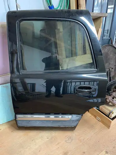 Drivers side rear door for 2001 through 2006 GM Yukon, or Chevy Tahoe. Black with tan interior. Exce...