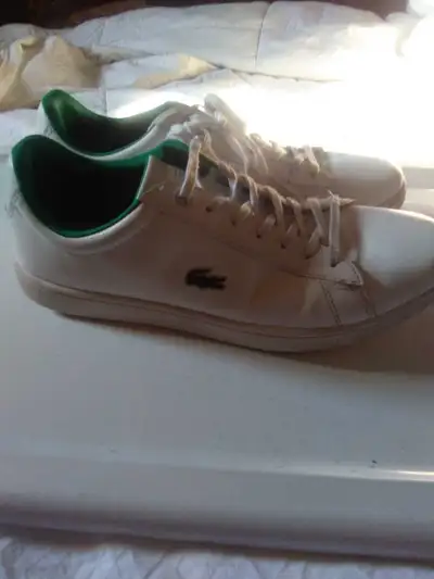 Step out in style with these Lacoste white sneakers, perfect for adding a touch of sporty elegance t...