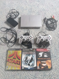 Playstation 2 with games, cables and controllers