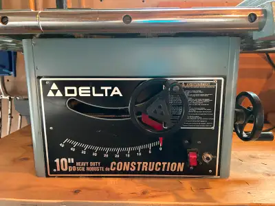Delta 10” heavy duty construction table saw with original metal stand as well as a plywood stand on...