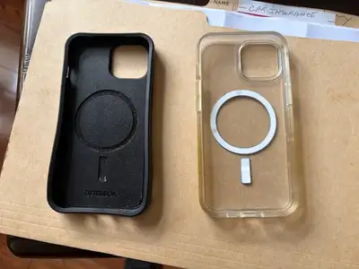 Two I-14 phone cases. Black one is an Otterman.