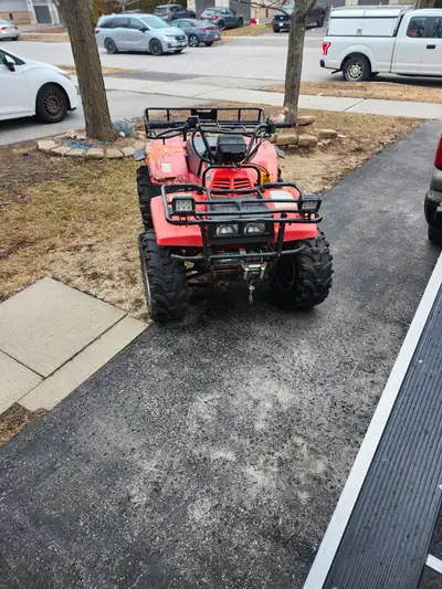 Suzuki quad runner 250 4x4 with super low and winch. Agm battery with led lights. Rough shape but wi...